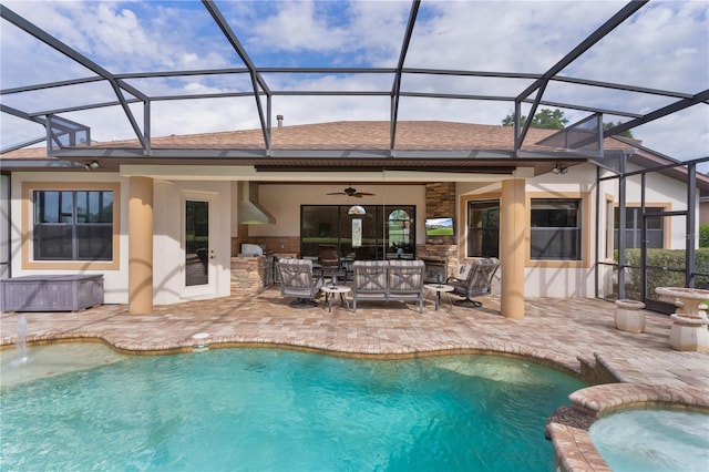 view of pool with a patio, ceiling fan, a pool with connected hot tub, and glass enclosure