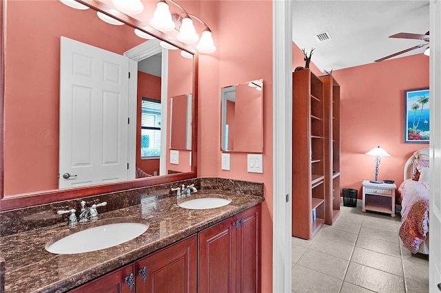 ensuite bathroom with double vanity, tile patterned floors, and ceiling fan
