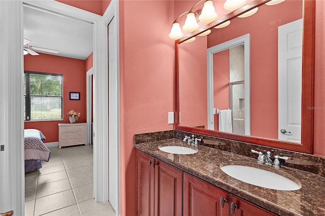 full bath with double vanity, tile patterned floors, a ceiling fan, and ensuite bathroom