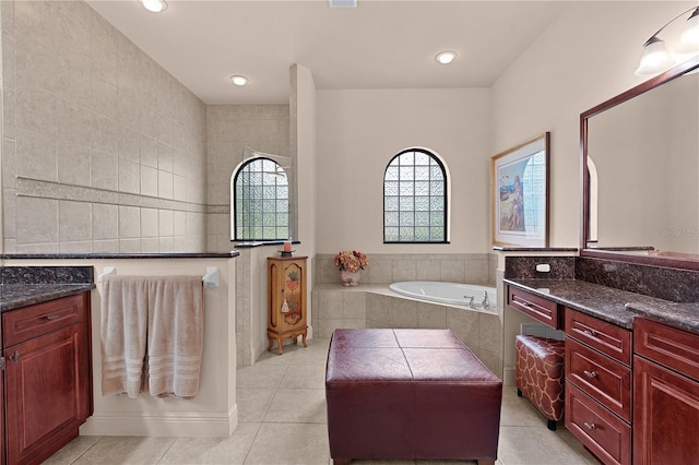 bathroom featuring a garden tub, tile patterned floors, vanity, and recessed lighting