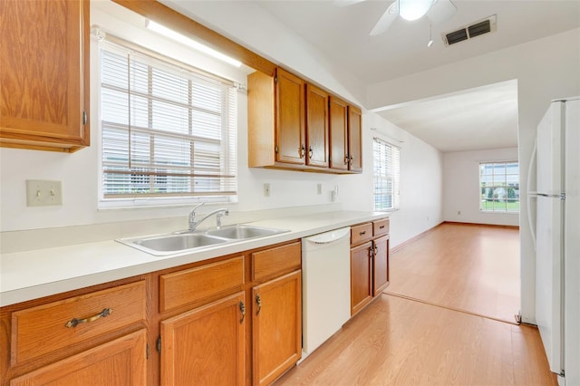 1467 Disston Ave, Clermont, FL 34711 - kitchen with white appliances, light wood finished floors, light countertops, and a ceiling fan