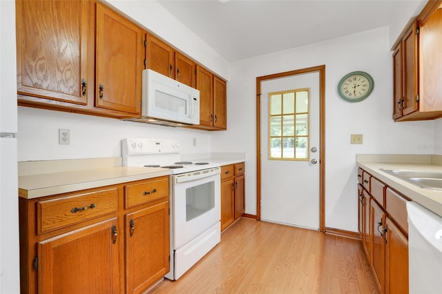 1467 Disston Ave, Clermont, FL 34711 - kitchen featuring white appliances, light wood-type flooring, light countertops, and brown cabinets