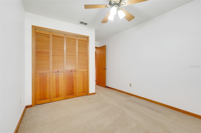 1467 Disston Ave, Clermont, FL 34711 - unfurnished bedroom featuring light colored carpet, a closet, and ceiling fan
