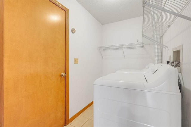 1467 Disston Ave, Clermont, FL 34711 - washroom featuring washing machine and dryer, light tile patterned floors, and a textured ceiling