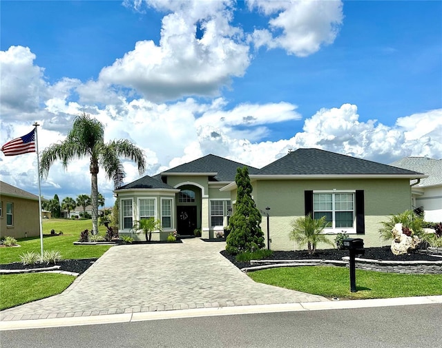 12183 SE 178th St, Summerfield, FL 34491 - view of front facade featuring a front lawn, stucco siding, and driveway