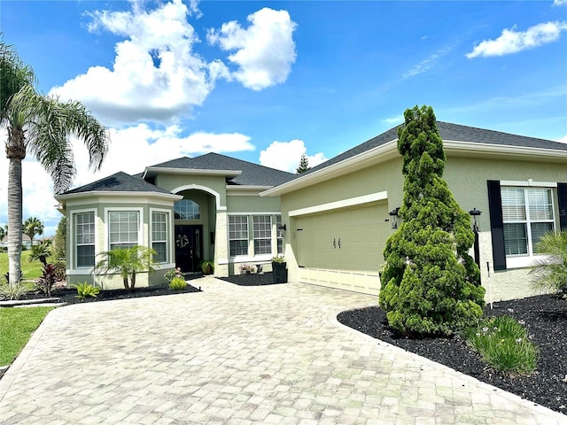 12183 SE 178th St, Summerfield, FL 34491 - single story home with stucco siding, an attached garage, and decorative driveway