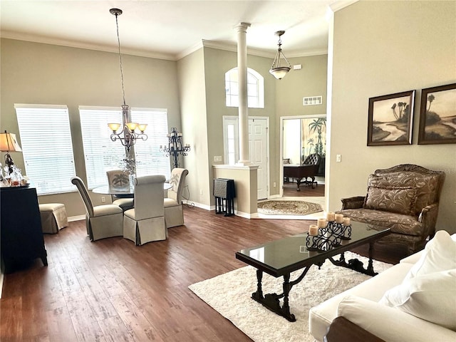 12183 SE 178th St, Summerfield, FL 34491 - living area featuring ornate columns, ornamental molding, plenty of natural light, wood finished floors, and a towering ceiling