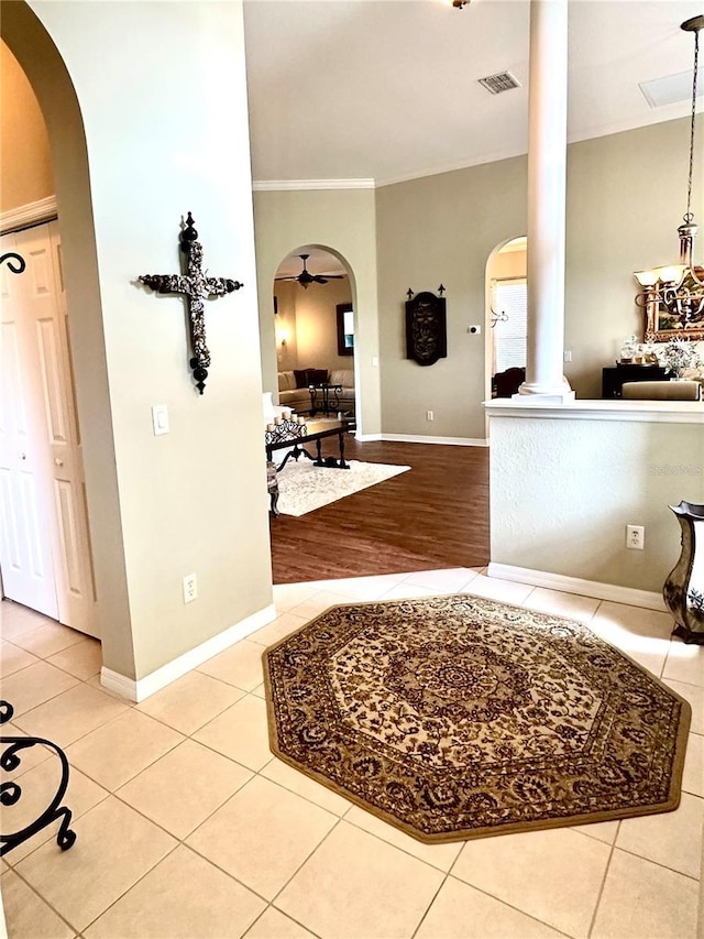 12183 SE 178th St, Summerfield, FL 34491 - tiled foyer with ornate columns, arched walkways, and ornamental molding