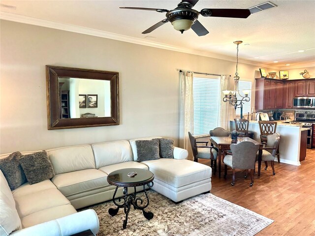 12183 SE 178th St, Summerfield, FL 34491 - living room with light wood-type flooring, crown molding, ceiling fan, and a chandelier