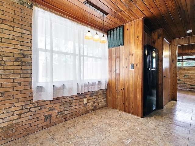 6731 Lake Griffin Rd, Lady Lake, FL 32159 - spare room featuring wooden ceiling, brick wall, and wood walls