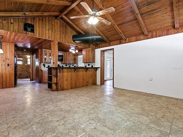 6731 Lake Griffin Rd, Lady Lake, FL 32159 - kitchen featuring wood walls, dark countertops, a wooden ceiling with exposed beams, open shelves, and brown cabinetry