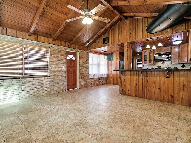 6731 Lake Griffin Rd, Lady Lake, FL 32159 - kitchen featuring black microwave, dark countertops, a wooden ceiling with exposed beams, wood walls, and a ceiling fan