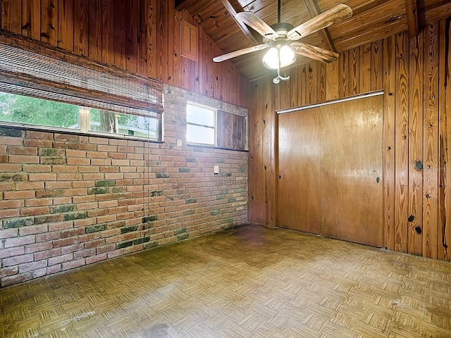 6731 Lake Griffin Rd, Lady Lake, FL 32159 - spare room featuring brick wall, wooden ceiling, wood walls, and ceiling fan
