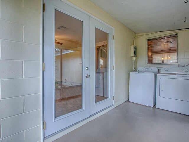 6731 Lake Griffin Rd, Lady Lake, FL 32159 - laundry area featuring concrete block wall, french doors, and separate washer and dryer