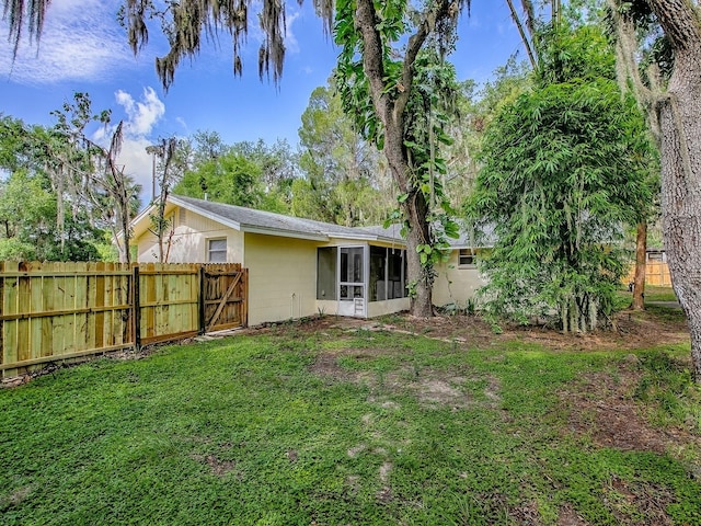 6731 Lake Griffin Rd, Lady Lake, FL 32159 - rear view of property featuring a sunroom and a fenced backyard
