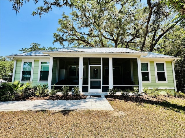 3607 Umbrella Tree Ln, Oxford, FL 34484 - back of house with a sunroom and a metal roof