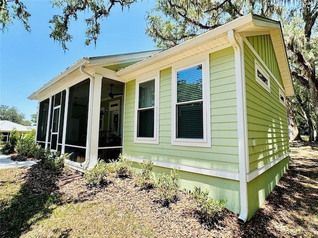3607 Umbrella Tree Ln, Oxford, FL 34484 - view of home's exterior with a sunroom