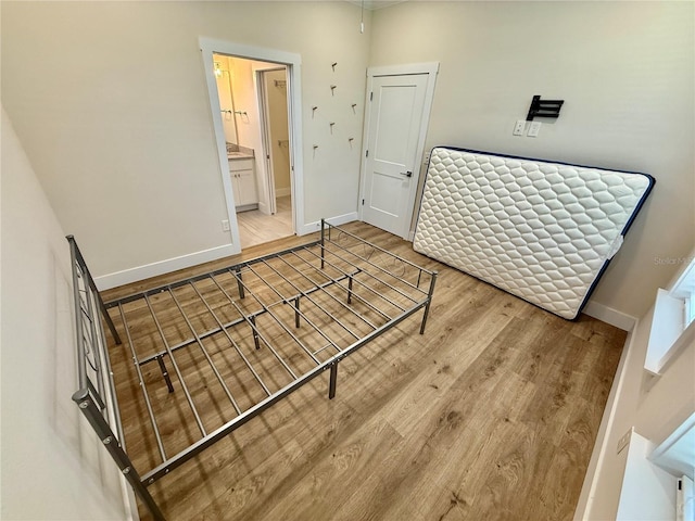 3607 Umbrella Tree Ln, Oxford, FL 34484 - unfurnished bedroom with wood finished floors and connected bathroom