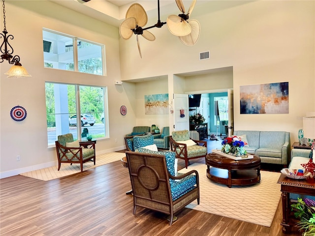 3607 Umbrella Tree Ln, Oxford, FL 34484 - living area with wood finished floors, a towering ceiling, and healthy amount of natural light