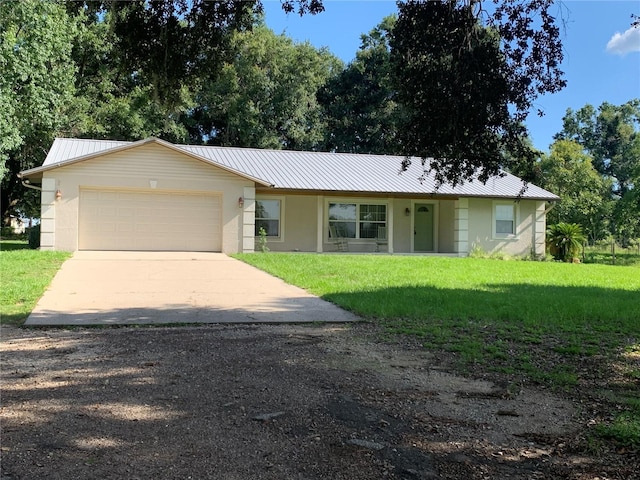2530 Shady Ln, Groveland, FL 34736 - ranch-style house featuring driveway, a garage, a front yard, stucco siding, and a metal roof