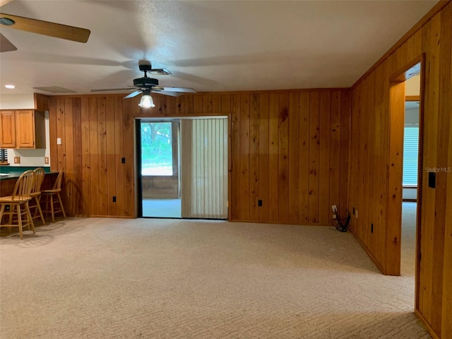 2530 Shady Ln, Groveland, FL 34736 - unfurnished living room with a ceiling fan, light carpet, and wooden walls