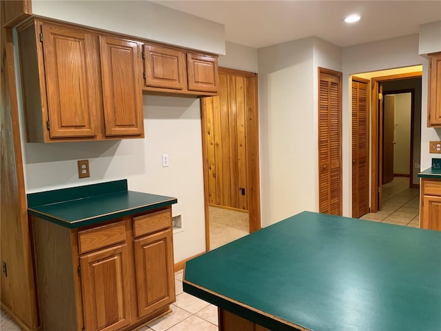 2530 Shady Ln, Groveland, FL 34736 - kitchen with light tile patterned flooring, dark countertops, recessed lighting, and brown cabinets