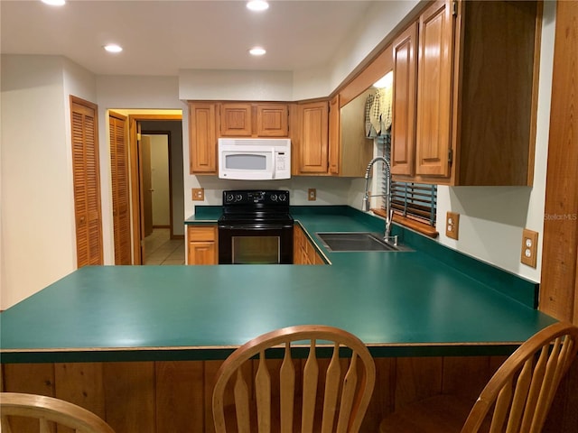 2530 Shady Ln, Groveland, FL 34736 - kitchen with white microwave, black / electric stove, recessed lighting, light tile patterned floors, and a peninsula