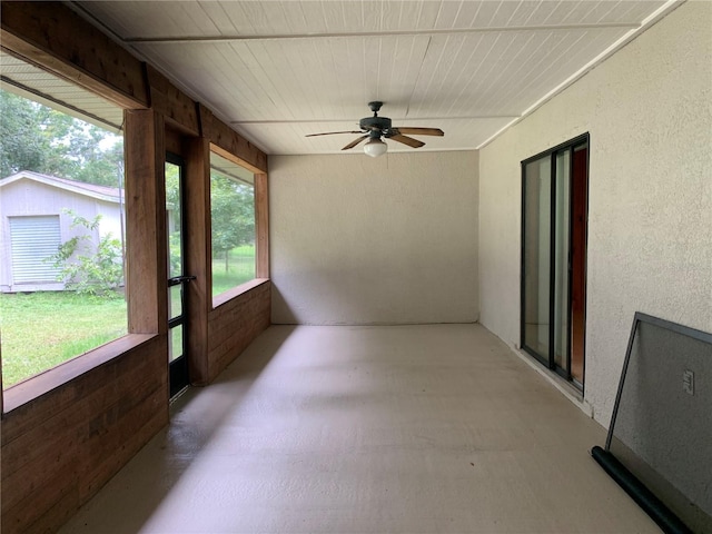 2530 Shady Ln, Groveland, FL 34736 - unfurnished sunroom with a ceiling fan, a textured wall, and wooden ceiling