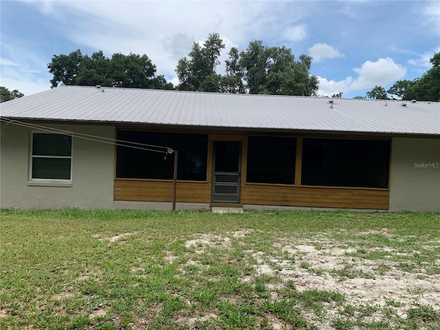 2530 Shady Ln, Groveland, FL 34736 - rear view of property with stucco siding and a metal roof