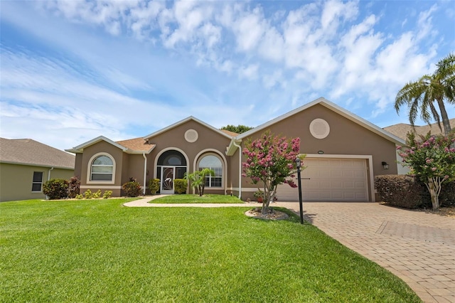 4826 Sable Ridge Ct, Leesburg, FL 34748 - view of front of home with stucco siding, an attached garage, decorative driveway, and a front lawn