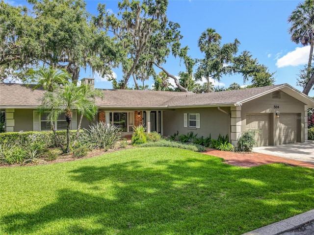 504 Banning Beach Rd, Tavares, FL 32778 - ranch-style home with an attached garage, stucco siding, a front yard, and driveway