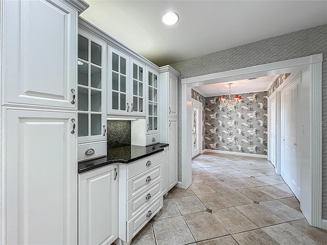504 Banning Beach Rd, Tavares, FL 32778 - bar with wallpapered walls, a chandelier, and light tile patterned flooring