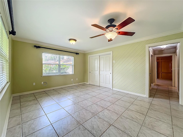504 Banning Beach Rd, Tavares, FL 32778 - unfurnished bedroom featuring crown molding, a closet, light marble finish floors, and a ceiling fan