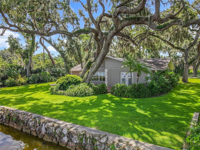 504 Banning Beach Rd, Tavares, FL 32778 - view of side of property with a yard