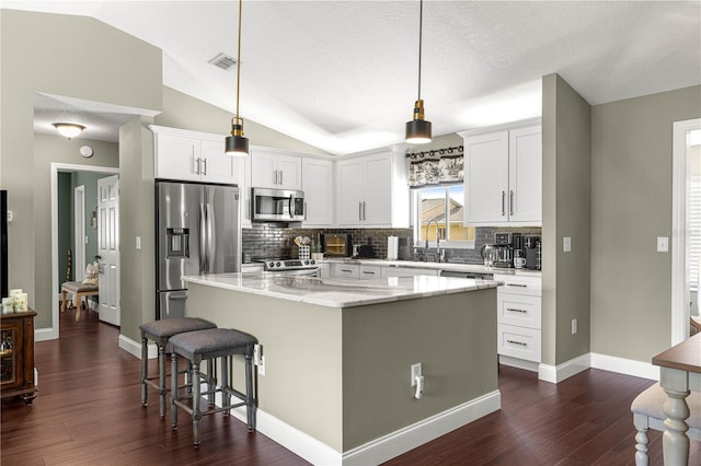 9790 SE 175th St, Summerfield, FL 34491 - kitchen with appliances with stainless steel finishes, tasteful backsplash, a center island, dark wood finished floors, and vaulted ceiling