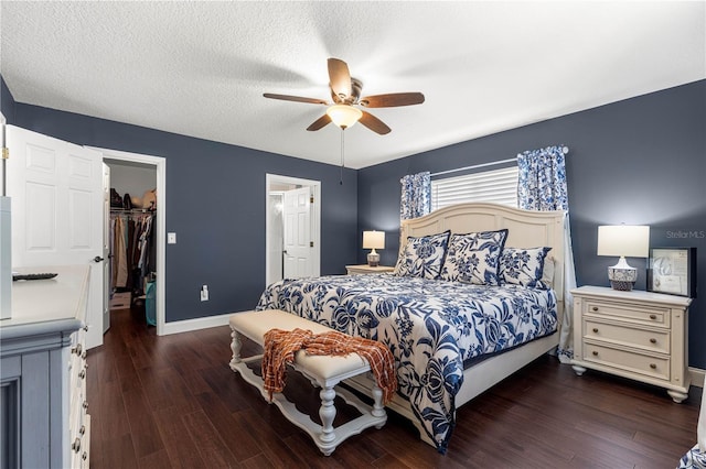 9790 SE 175th St, Summerfield, FL 34491 - bedroom featuring wood finished floors, a walk in closet, a closet, ceiling fan, and a textured ceiling