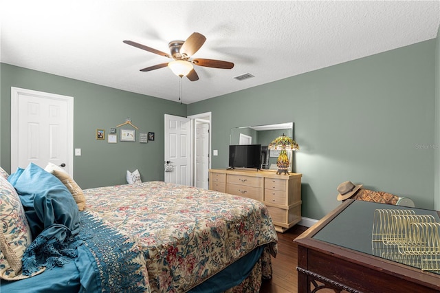 9790 SE 175th St, Summerfield, FL 34491 - bedroom featuring dark wood-style floors, ceiling fan, and a textured ceiling