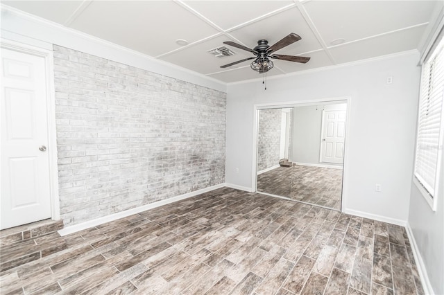 25 Jule Rd, Macclenny, FL 32063 - unfurnished bedroom featuring brick wall, wood finished floors, a closet, ornamental molding, and ceiling fan