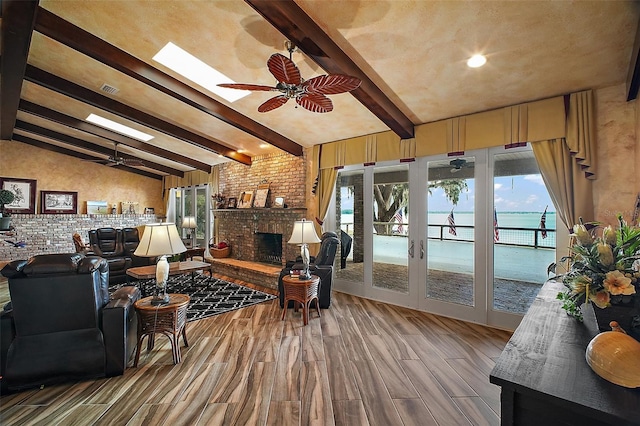 13033 SE 158th Ln, Weirsdale, FL 32195 - living area with ceiling fan, wood finished floors, a fireplace, and french doors