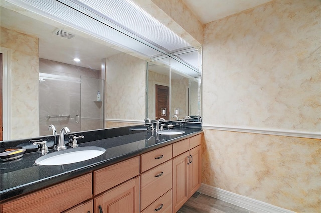 13033 SE 158th Ln, Weirsdale, FL 32195 - bathroom featuring double vanity, a stall shower, and wood finished floors