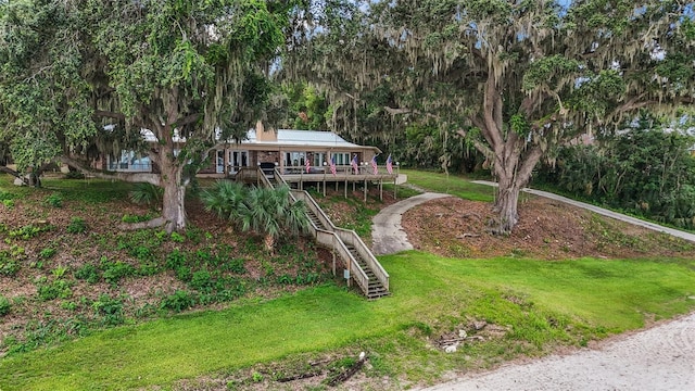 13033 SE 158th Ln, Weirsdale, FL 32195 - view of front of home featuring stairway, a front yard, and a deck