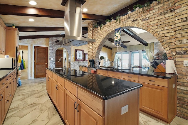 13033 SE 158th Ln, Weirsdale, FL 32195 - kitchen featuring black electric stovetop, an island with sink, island range hood, a ceiling fan, and beam ceiling