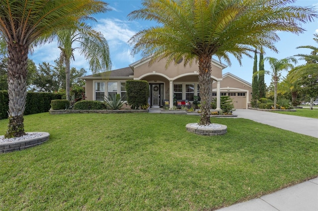4018 Chandler Estates Dr, Apopka, FL 32712 - view of front of house featuring driveway, an attached garage, stucco siding, and a front lawn