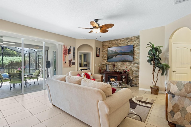 4018 Chandler Estates Dr, Apopka, FL 32712 - living room with ceiling fan, light tile patterned flooring, arched walkways, a sunroom, and a textured ceiling