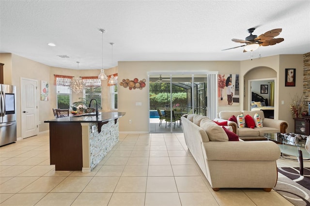 4018 Chandler Estates Dr, Apopka, FL 32712 - kitchen with smart refrigerator, dark countertops, a textured ceiling, light tile patterned floors, and open floor plan