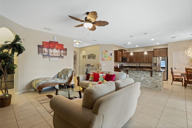 4018 Chandler Estates Dr, Apopka, FL 32712 - living room with light tile patterned flooring, arched walkways, a ceiling fan, and recessed lighting