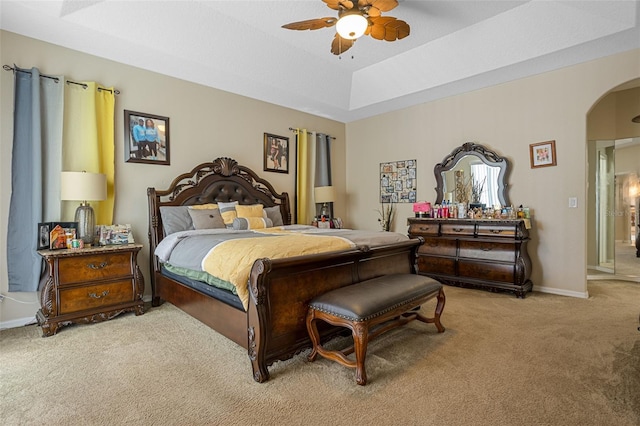 4018 Chandler Estates Dr, Apopka, FL 32712 - bedroom featuring arched walkways, light colored carpet, a tray ceiling, and ceiling fan