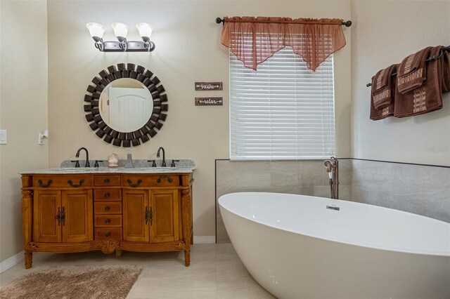 4018 Chandler Estates Dr, Apopka, FL 32712 - full bath featuring a freestanding bath, double vanity, healthy amount of natural light, and tile patterned flooring