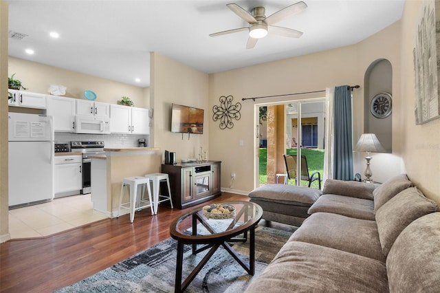 624 Terra Lago St, Davenport, FL 33897 - living room with light wood-style floors, ceiling fan, recessed lighting, and arched walkways