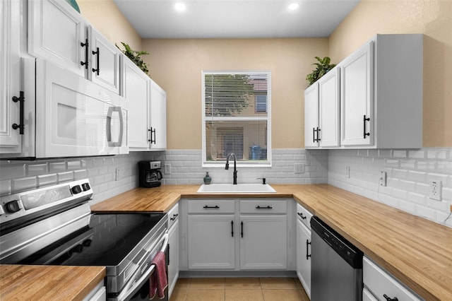 624 Terra Lago St, Davenport, FL 33897 - kitchen with wood counters, appliances with stainless steel finishes, backsplash, and recessed lighting